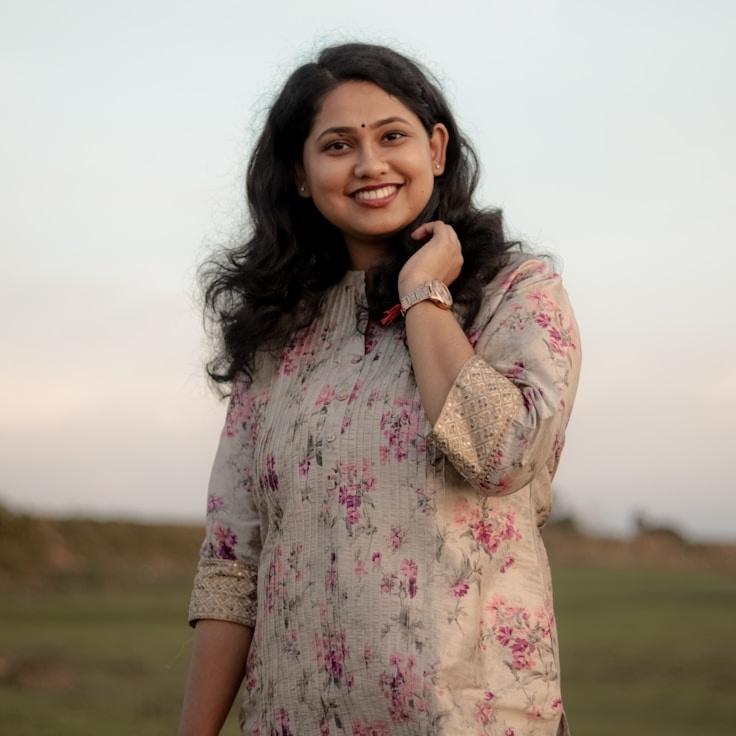 Nova Singh, Lead Design Curator at Market Flow Faint, reviewing corporate floral arrangements